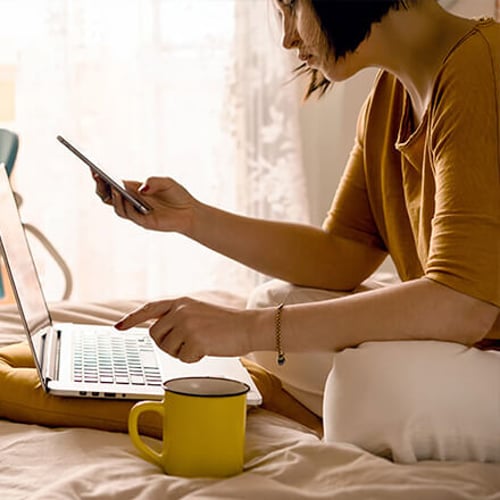 Woman on phone and laptop Stock image of woman on phone and laptop