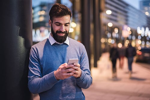 Man smiling while texting Man smiling while texting
