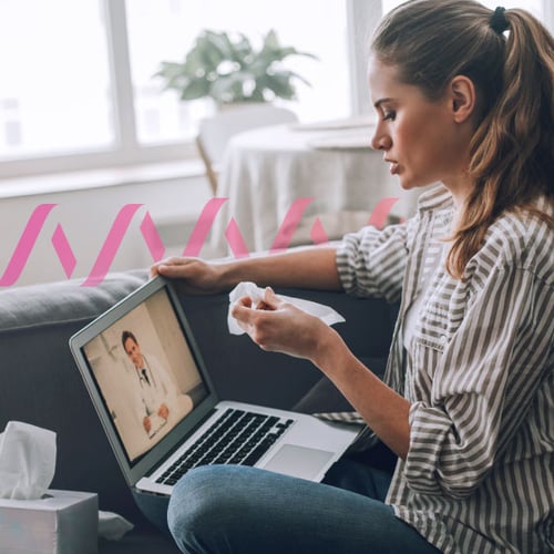 Ambient-Scribe-Telehealth-Blog.jpg Image of woman, sitting with a laptop. She’s holding a tissue and conducting a virtual doctor’s visit.