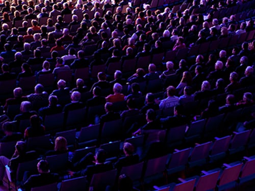 Illuminated Audience Seated audience in a theater.