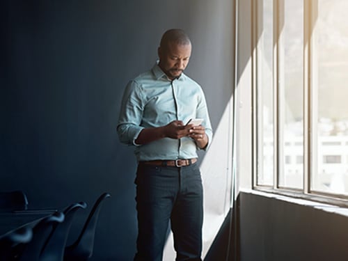 Shot of a mature businessman using a mobile phone in a modern office Shot of a mature businessman using a mobile phone in a modern office