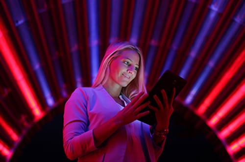 Businesswoman with tablet pc against high tech lights background Businesswoman with tablet pc against high tech lights background